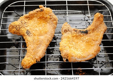 Two Crispy Cooked Pork Chops Hot From the Oven