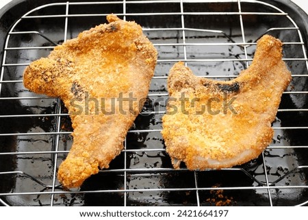 Two Crispy Cooked Pork Chops Hot From the Oven