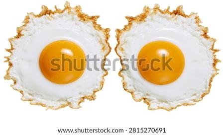 Two crispy fried eggs with bright yellow yolks and golden brown edges