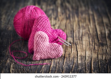 Two Crochet Pink Hearts On Wooden Background