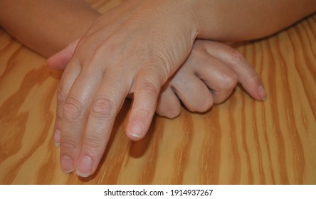 Two Crossed Hands Of A Lady On A Table With No Manicure Done - Tapping Fingers On The Table