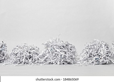 Two cubes made of compacted shredded paper against a white background.