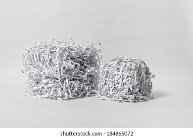 Two cubes made of compacted shredded paper against a white background.