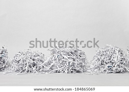 Two cubes made of compacted shredded paper against a white background.