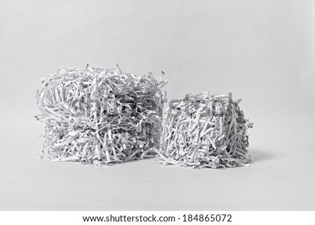Two cubes made of compacted shredded paper against a white background.