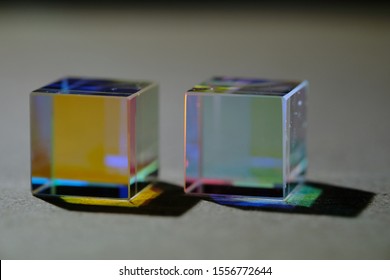 two cubic prisms that refract light and divide it into a color spectrum