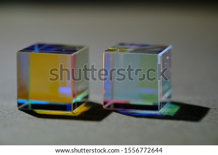 two cubic prisms that refract light and divide it into a color spectrum