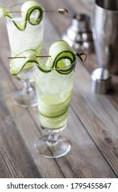 Two Cucumber Spritzer Mocktails Ready For Drinking With Metal Shaker Bottle Beside.