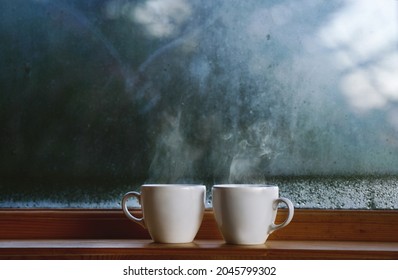 Two Cup Of Hot Drink Coffee Near Window, Water Condensation On Window Glass, Early Morning, Wake Up Concept