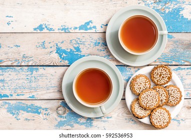 Two Cup Of Tea And Saucer With Cookies On The Table. Top View.