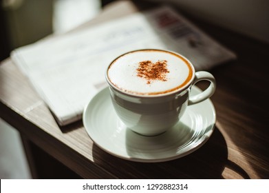 Two cups of cappuccino with latte art on wooden background and newspaper. Cup of cappuccino with newspaper on the table.Coffee Shop Cafe Latte Cappuccino Newspaper Concept  - Powered by Shutterstock