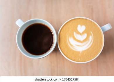 Two cups of coffee, different choice: black or white, espresso or capuchino, americano or latte. Different tastes in coffee concept.