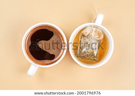 Two cups with coffee and green tea on a beige background.