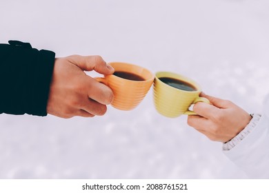 Two Cups Of Coffee In The Hands Of Happy Couple. Winter Theme