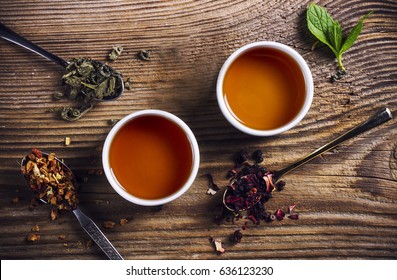 Two Cups Of Loose Leaf Tea On A Wooden Table, Top View