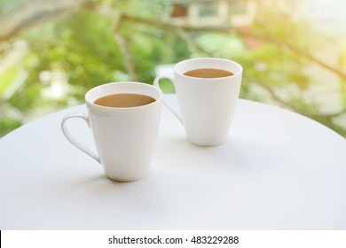 Two Cups Of Tea Or Coffee On Table On Garden Bright Background