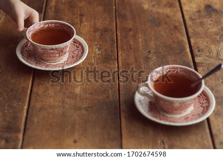 two cups of tea on a wooden table