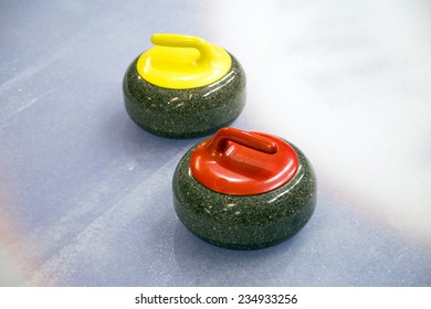 A two curling stone on the ice of a curling rink