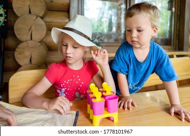 Two Cute Adorable Caucasian Blond Little Sibling Sitting At Table Home Yard And Have Fun Making With Mom Homemade Fruit Icecream. Young Happy Children Enjoy Cooking With Mother Outside. Family Love