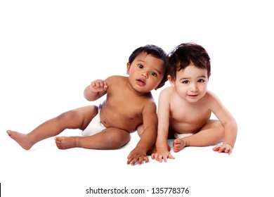 Two Cute Adorable Multi-ethnic Babies Sitting Together, Childhood Concept, On White.