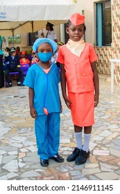 Two Cute African Girls Or Students In Air Hostess And Medical Outfit Standing Together Outdoor In A School Gathering As They Celebrate Career Day