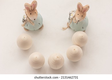 Two cute Easter rabbits, eggs on white background, flat lay, top view. Easter composition, copy space
