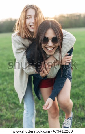 Similar – Happy women embracing and laughing over nature background