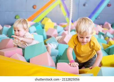 Two Cute Little Boys Twins Plays With Soft Cubes In The Dry Pool In Play Center