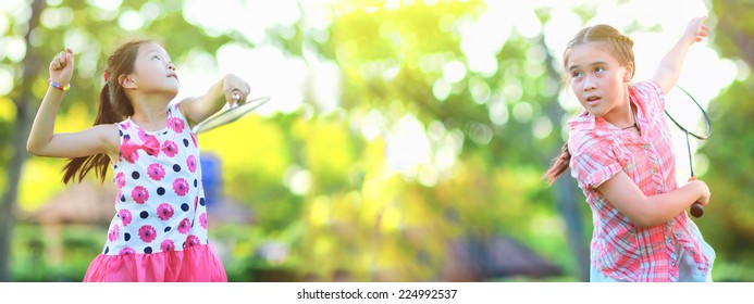 Two Cute little girl playing badminton