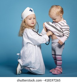 two cute little girls playing doctor