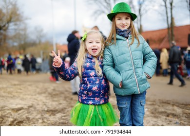 Two cute little girls wearing green hats and accessories celebrating St. Patrick's day in Vilnius. Children having fun at traditional irish festival. - Powered by Shutterstock