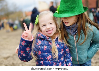 Two cute little girls wearing green hats and accessories celebrating St. Patrick's day in Vilnius. Children having fun at traditional irish festival. - Powered by Shutterstock