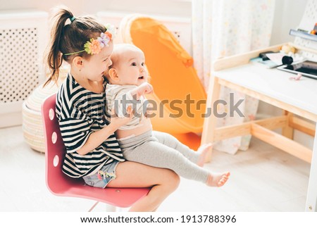 Similar – Relaxed mother and sons playing over the bed