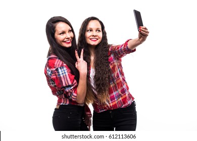 two cute twins girls with mobile phones make selfie - Powered by Shutterstock