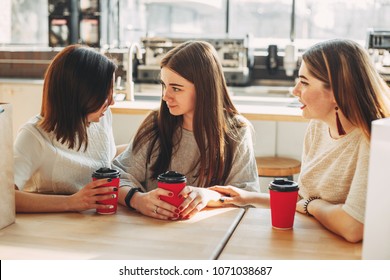 Two cute young women cheer up their sad friend. Friendship, help, support, care, attention, togetherness - Shutterstock ID 1071038687