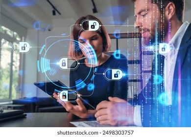 Two cybersecurity professionals analyzing data on tablets, with digital lock graphics and binary code overlay on a modern office background, concept of data protection and internet security - Powered by Shutterstock