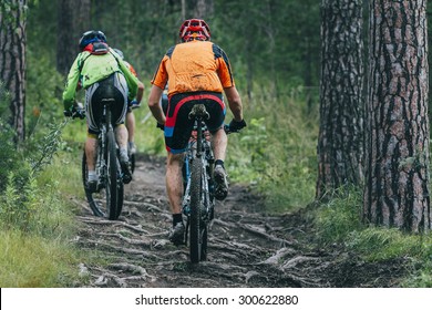 two cyclist  mountainbiker during a race in the woods - Powered by Shutterstock