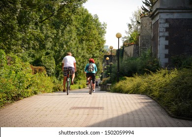 Two cyclist on the road. Man and woman on bike. Photo from behind. Photo taken in Louny, Czechia.
