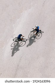 Two cyclist with shadow drop from the sun