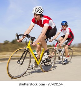 Two Cyclists Sprinting Past The Camera At High Speed