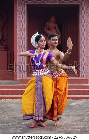 two dancer posing indian classical dance form Odissi. Ancient scriptures of india backdrop Classical Dance