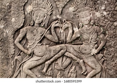 Two Dancing Women On 12th Century Relief Of The Bayon Temple, Cambodia. Historical Artwork On Wall Of Khmer Landmark In Angkor. UNESCO World Heritage Site.