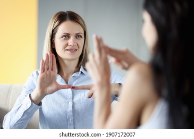 Two Deaf Women Talking Gestures At Home. Hearing Loss Disability Person Lifestyle Concept