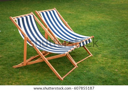 The two deck chairs on the lawn