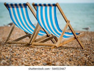  Two Deck Chairs On The Pebble Beach At Brighton, UK.