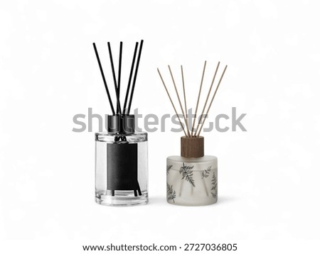 Two decorative glass reed diffusers with black and wooden caps