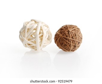 Two decorative wicker wooden balls on a white background