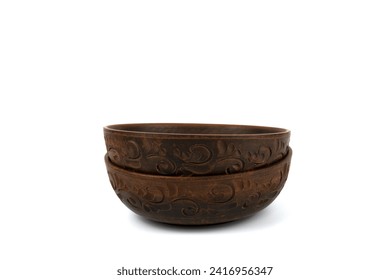 Two deep handmade clay plates in close-up. The bowl is isolated on a white background. Side view. Kitchen utensils, dishes for food.