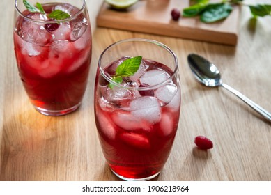 Two delicious cranberry cocktails with mint and lime