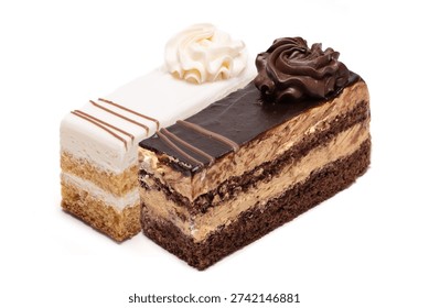 Two delicious portions of rectangular layered sponge cakes isolated on white. One features chocolate biscuit with mocha cream and dark frosting, the other is a vanilla biscuit with white cream. Both are decorated with elegant frosting swirls on top.